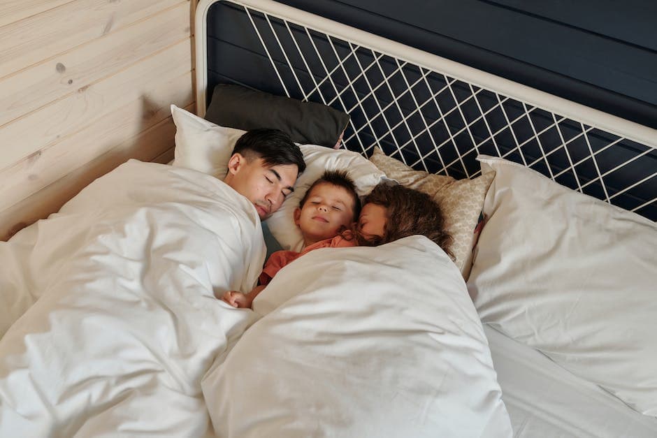 Padre y su hijo durmiendo juntos en una cama