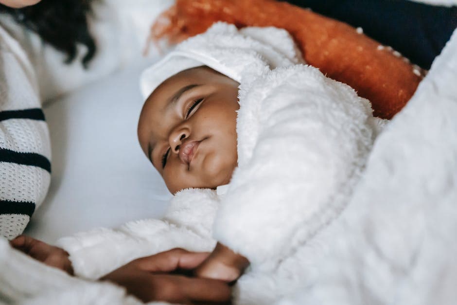 Madre y bebé durmiendo en una cama cómoda